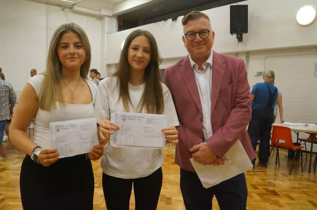 Kitty MacPherson, left, and Scarlet Dring are both delighted with their results, with a raft of 8s and 9s between them. They are pictured with headteacher Simon Porter and both will be staying at De Aston for A-levels: Media, Geography and Photography for Scarlet; English Literature, Politics and History for Kitty.