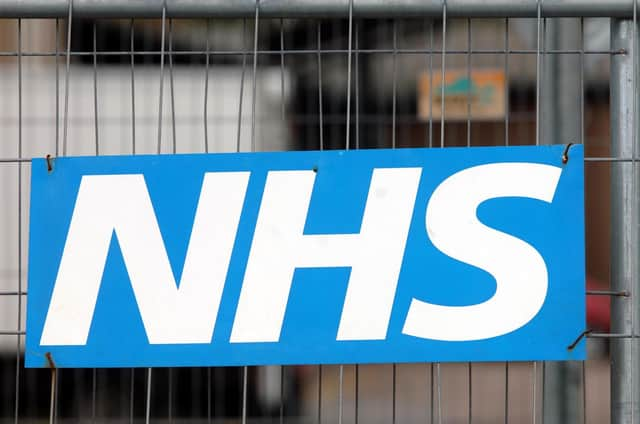 An NHS sign on a fence at Broomfield Hospital in Chelmsford.