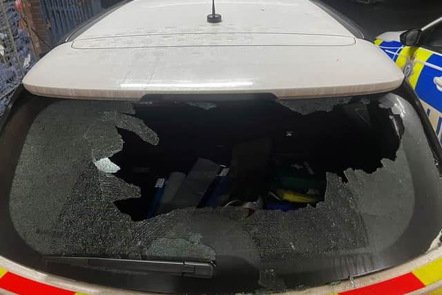 A police car is out of action after its window was smashed.