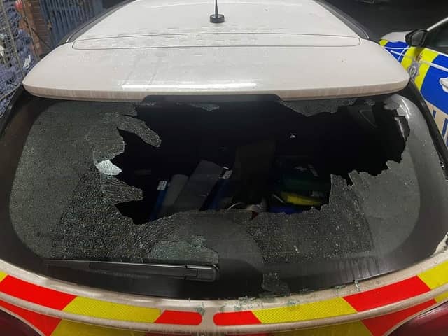 A police car is out of action after its window was smashed.