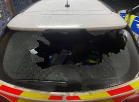 A police car is out of action after its window was smashed.