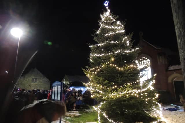 The tree lights switch on at Navenby in 2024.