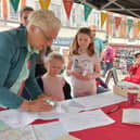 Writer Sonya Hundal pictured in a writing activity at Spalding Pumpkin Festival in 2023.