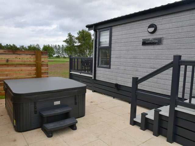 Luxury lodges have hot tubs and views across the golf course.