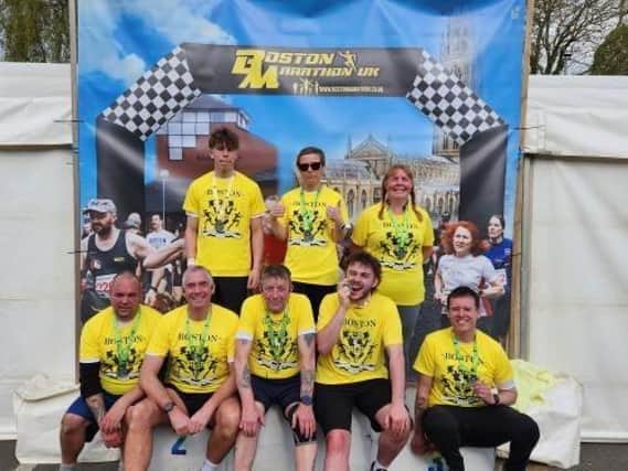 Team Asda proudly show their finishers' t-shirts and medals