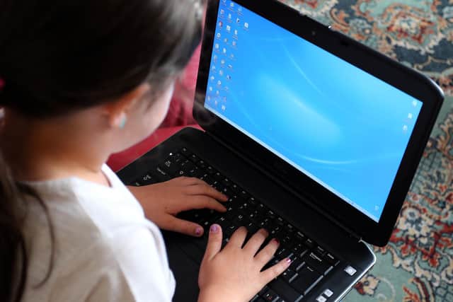 File photo dated 21/08/14 of a child using a laptop computer. Research, by Dr Killian Mullan at Oxford University concludes that youngsters are combining new technology with every day life.
