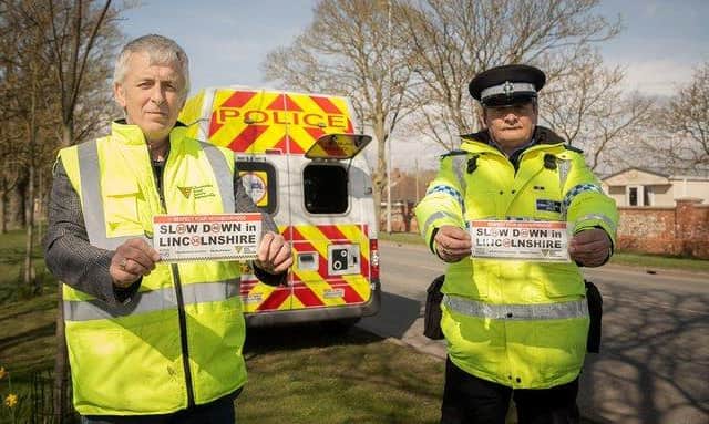 PCSO Bunker (right) launching the countywide 'Slow down' sticker campaign in Skegness with John Siddle from the Lincolnshire Road Safety Partnership.