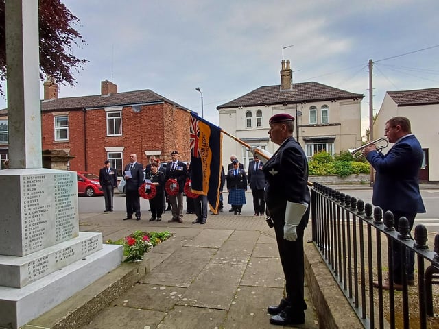 Bugler Rob Tinker plays the Last Post as the Standard is lowered