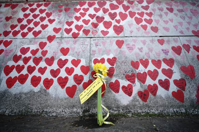 File photo dated 23/3/2022 of flowers by the The National Covid Memorial Wall in London. Bereaved families have warned they may take legal action against the Government over delays to starting the coronavirus public inquiry. The Covid-19 Bereaved Families for Justice group is considering bringing a judicial review over the failure to provide a setting up date for the inquiry into the Government's handling of the pandemic. Issue date: Monday June 27, 2022.