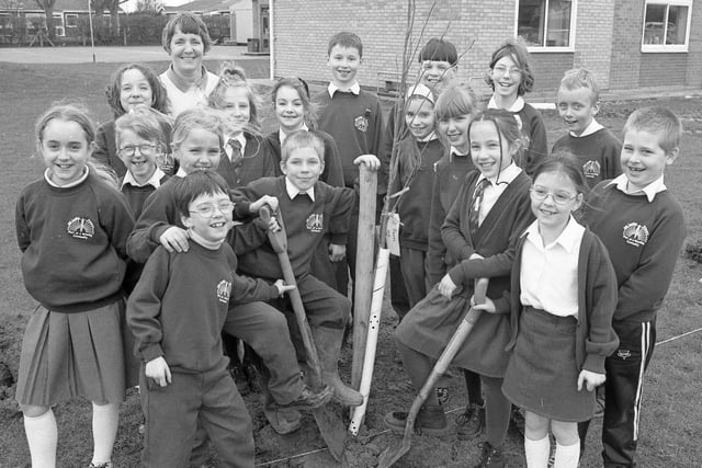 Children from Old Leake Primary School's environmental club and their teacher Pam Hyde planting 24 trees in an avenue to mark the new millennium. The avenue would lead to a stage where a time capsule was to be buried.