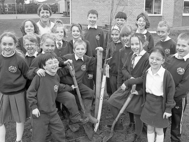 Children from Old Leake Primary School's environmental club and their teacher Pam Hyde planting 24 trees in an avenue to mark the new millennium. The avenue would lead to a stage where a time capsule was to be buried.