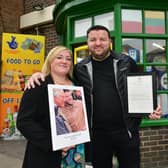 Erhan Akyuz with his wife Emma Akyuz outside his shop, which was visited by Prince Charles.