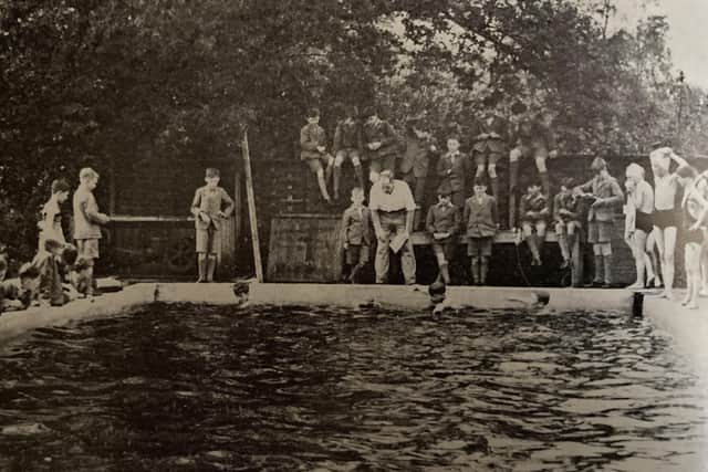 Teacher Sgt. William Raw starting swimming races in the original pool – which was built by a number of boys who dug out and added to the size of a lily pond for conversion to the school swimming pool!