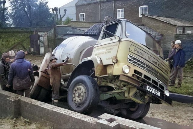 A cement truck encounters difficulty in February 1977 as part of the build.