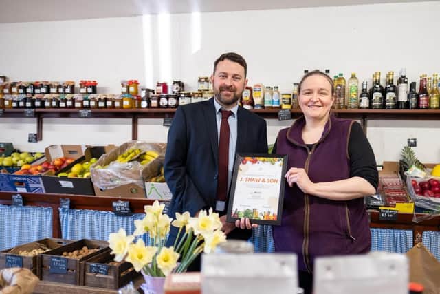 Chris Yorston, head of waste at Lincolnshire County Council, presenting Cat Shaw, co-owner at J. Shaw & Son, with her Lincolnshire loose fruit and vegetable champion certificate. Photo: LCC