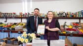 Chris Yorston, head of waste at Lincolnshire County Council, presenting Cat Shaw, co-owner at J. Shaw & Son, with her Lincolnshire loose fruit and vegetable champion certificate. Photo: LCC