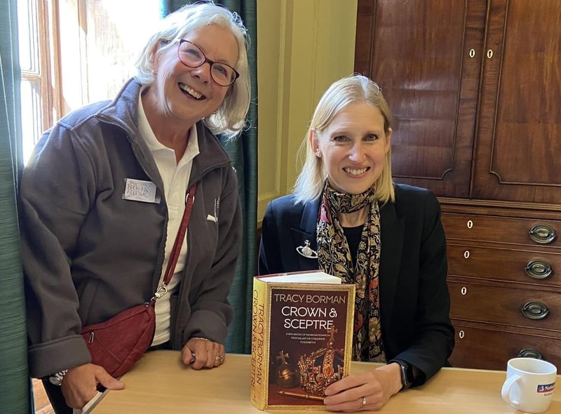 Festival volunteer Gail Cooper getting her copy of Crown and Sceptre signed by Tracy Borman.