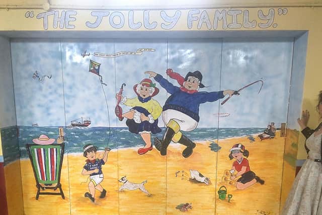 A mural of the Jolly Fisherman created by Dee Dee Lee (right).