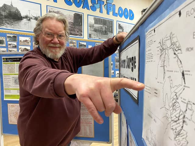 Oli Alflatt points to a map showing the 1953 Storm Surge.