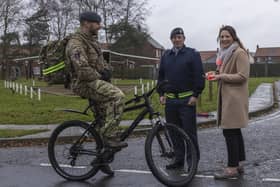 General Manager Jessica De Ruyter and Sergeant Daz Pollard hand bicycle lights to RAF Coningsby personnel. Photo: © UK MOD Crown Copyright 2023