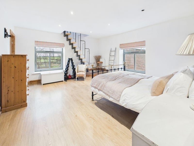 Another angle on bedroom one, showing stairs to the mezzanine area.