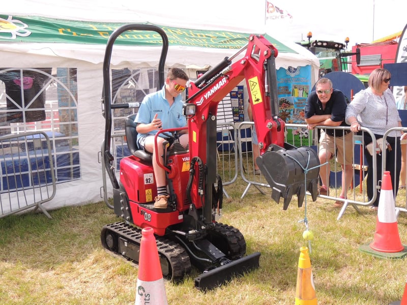 Charlie Baxter of Howell takes on the mini digger challenge on Heckington Young Farmers' stand.