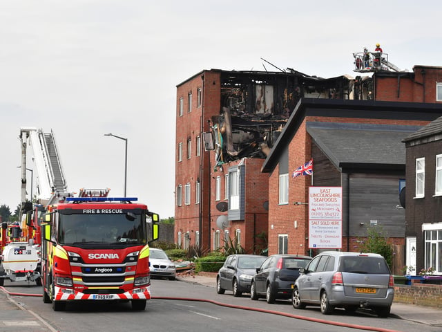 Firefighters can be seen on board the second aerial appliance behind the property.