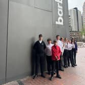 TMA students get ready to play at the Barbican Centre. They are Austeja, Bogdans, Danielius, Viktori, Lexi, and Ella, all violin players, and Trystan and Harry, viola players.