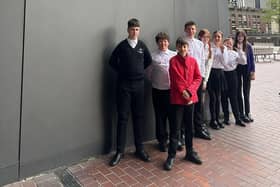 TMA students get ready to play at the Barbican Centre. They are Austeja, Bogdans, Danielius, Viktori, Lexi, and Ella, all violin players, and Trystan and Harry, viola players.