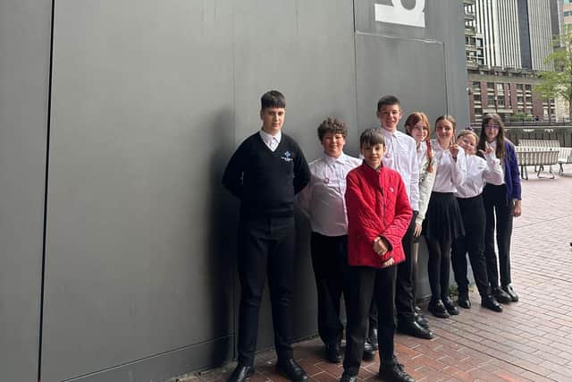 TMA students get ready to play at the Barbican Centre. They are Austeja, Bogdans, Danielius, Viktori, Lexi, and Ella, all violin players, and Trystan and Harry, viola players.
