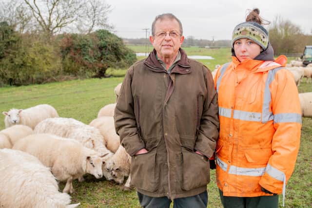 George Robinson and Keira Rhodes with their flock of sheep. Photo: John Aron Photography