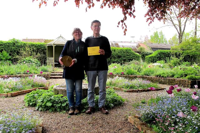 Pam and Mark in their garden with their sundial