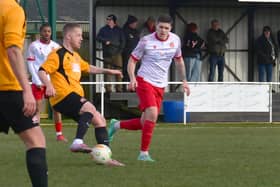Terry Hawkridge on the ball, watched by Marshall Young.
