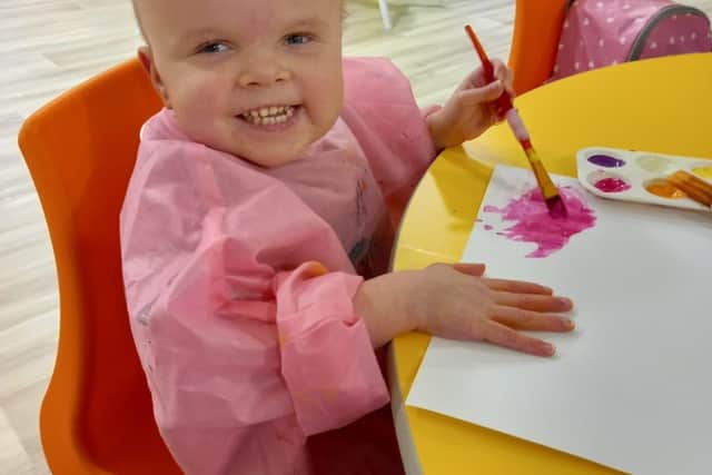 Olivia enjoying some painting during respite at Andy's Children's Hospice.