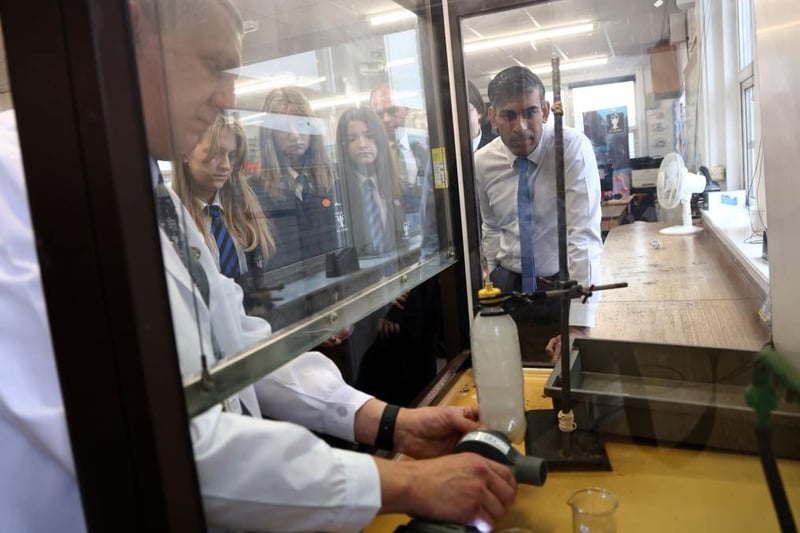 Prime Minister Rishi Sunak watches a science experiment where cigarette smoke was passed through cotton wool, during a visit to Giles Academy in Old Leake, on November 8. (Photo by Darren Staples - WPA Pool/Getty Images)