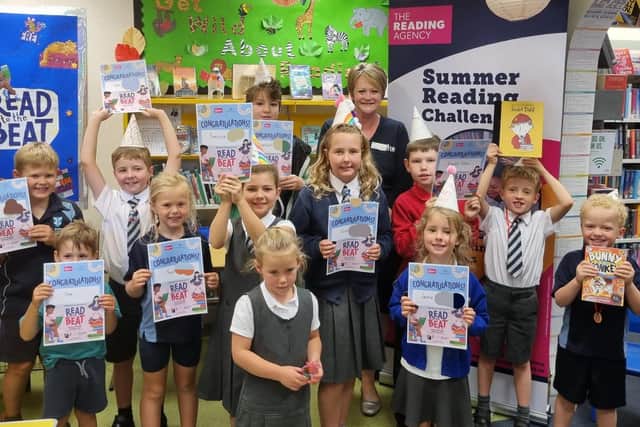 Children who completed the summer reading challenge with their certificates and Woodhall Spa Library Manager Jude Hall.