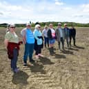 Anwick residents walking along a footpath through the field where the anaerobic digester is planned. Photo: David Dawson