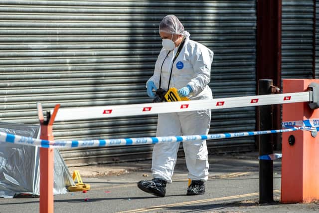 A police forensic officer at the scene in Fountain Lane.