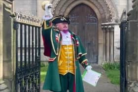 Sleaford Town Crier John Griffiths makes the proclamation in Sleaford Market Place for the King's Coronation anniversary. Photo: David Dawson