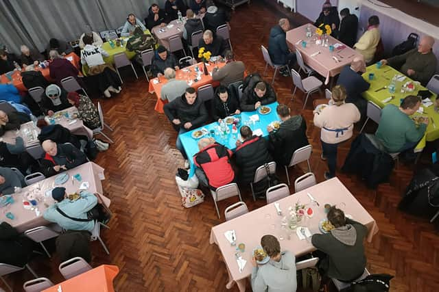 Residents pictured enjoying free hot lunches at Centenary Methodist Church in the run-up to Christmas.