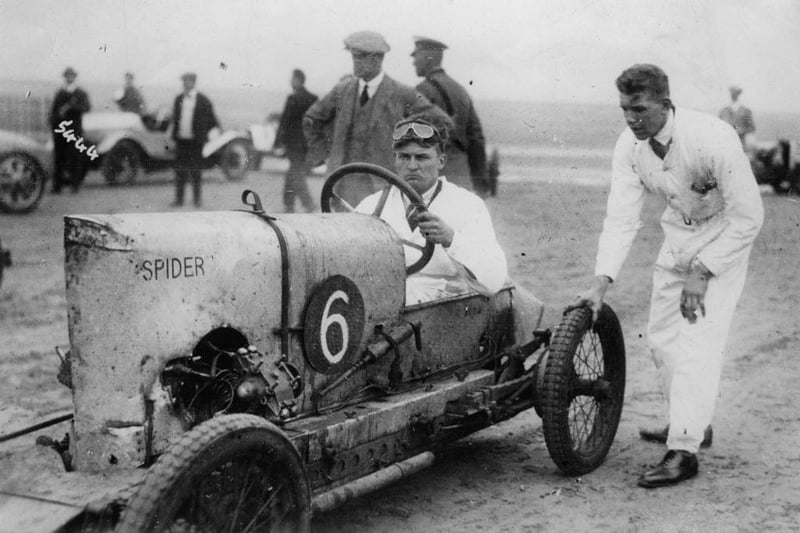Racing driver Fraser Nash with a race car on the beach at Skegness around 1930.