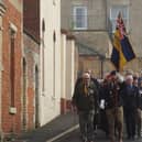 Members of the Royal British Legion lead the parade from the market place to the parish church.