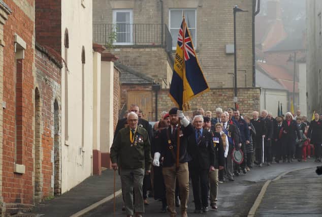 Members of the Royal British Legion lead the parade from the market place to the parish church.