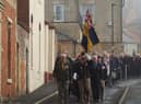 Members of the Royal British Legion lead the parade from the market place to the parish church.
