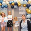 Some of the youngsters collecting their Summer Reading Challenge prizes. From left - Lola Hymers, aged seven, Freya Hymers, nine, Ella Parker, aged three and Sleaford Library Manager Charlotte Harris.