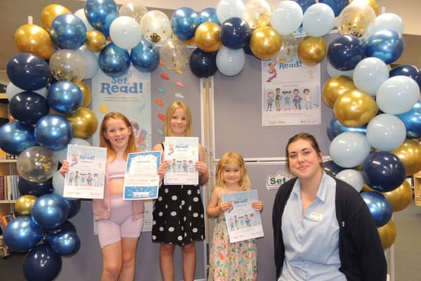 Some of the youngsters collecting their Summer Reading Challenge prizes. From left - Lola Hymers, aged seven, Freya Hymers, nine, Ella Parker, aged three and Sleaford Library Manager Charlotte Harris.