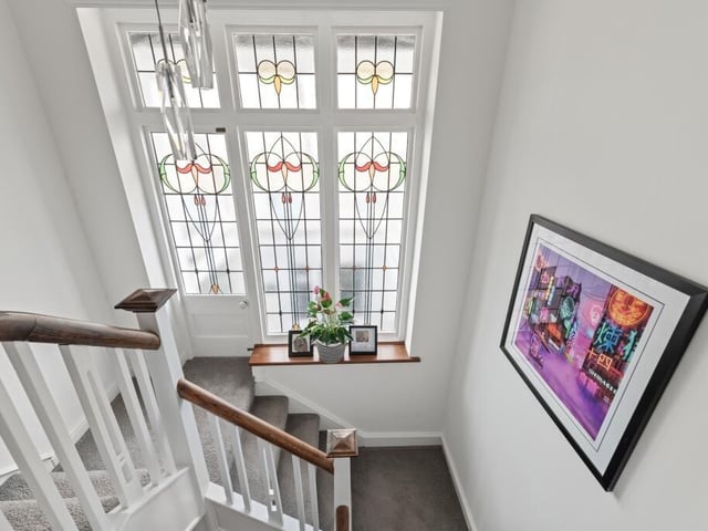 The original leaded door and matching satiles glass window panel.