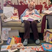 Happy Gwen Chapman surrounded by hundreds of cards and well wishes after a care home appeal to help her celebrate her 102nd birthday.