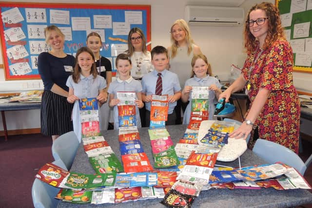 L-R (back) parent Joy Knight, St George’s sixth former Libby Gallett, teaching assistant Meagan Kendrick, parent Sasha Harvey, teacher Mary Purchase, (front) Kamilla, Ellie, Zach and Gracie, all aged eight.