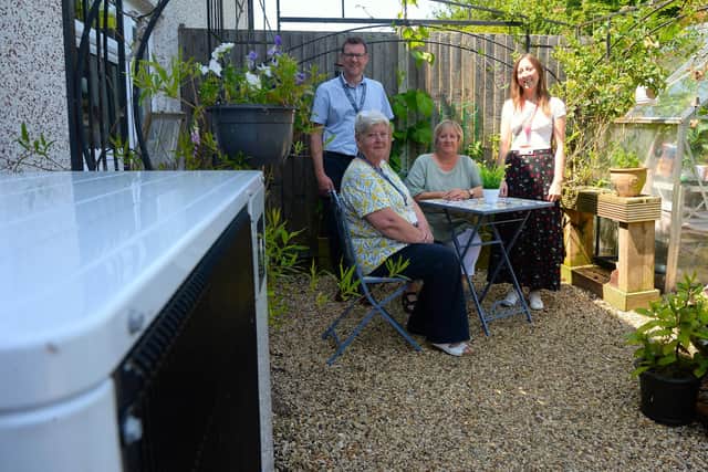 Left to right: SKDC’s Head of Technical Services, Mark Rogers, Cabinet Member for Housing Virginia Moran, tenant Debi Palmer and E.ON Project Administrator Claire Huzar. Debi has had an air source heat pump (left) fitted. (Photo: SKDC
